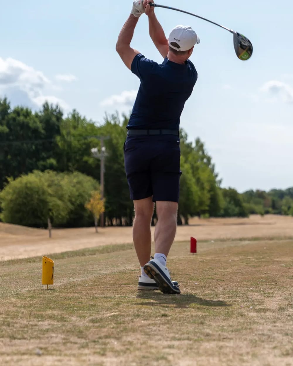 A golfer driving off the tee at a charity golf day