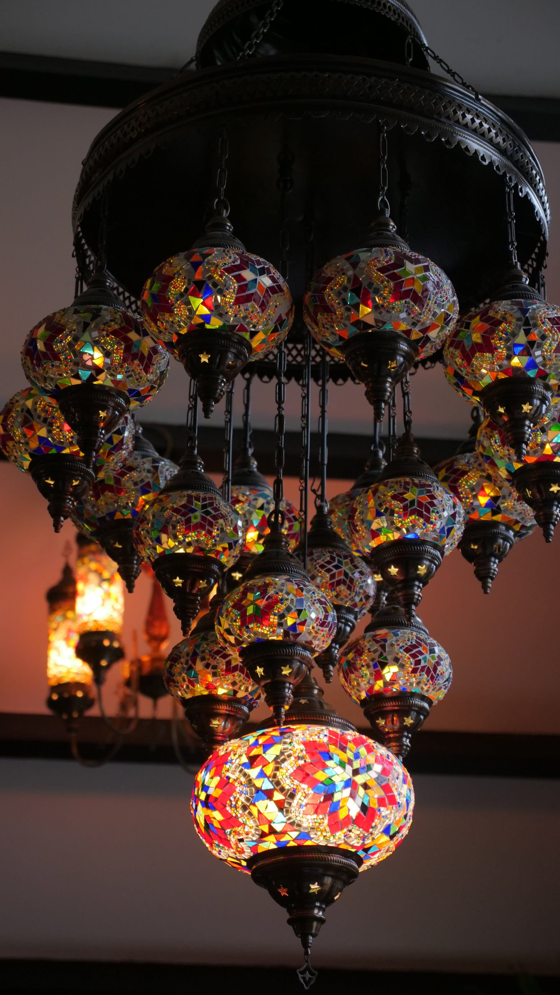 Coloured glass lanterns hanging above a dining room